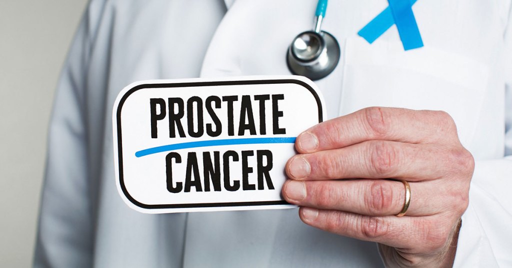 Doctor holding prostate cancer card.